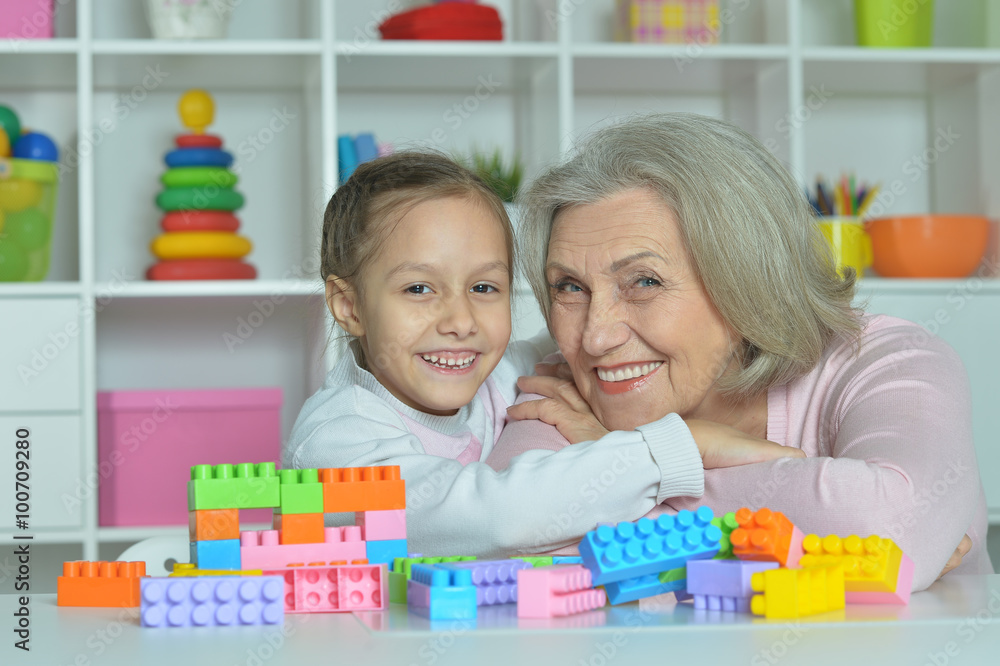 Fototapeta premium Grandmother with granddaughter playing together