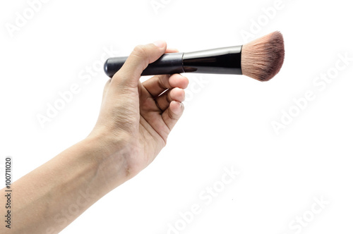 hand holding makeup brush