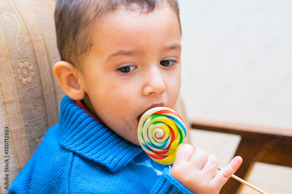 sad boy eating Lollipop