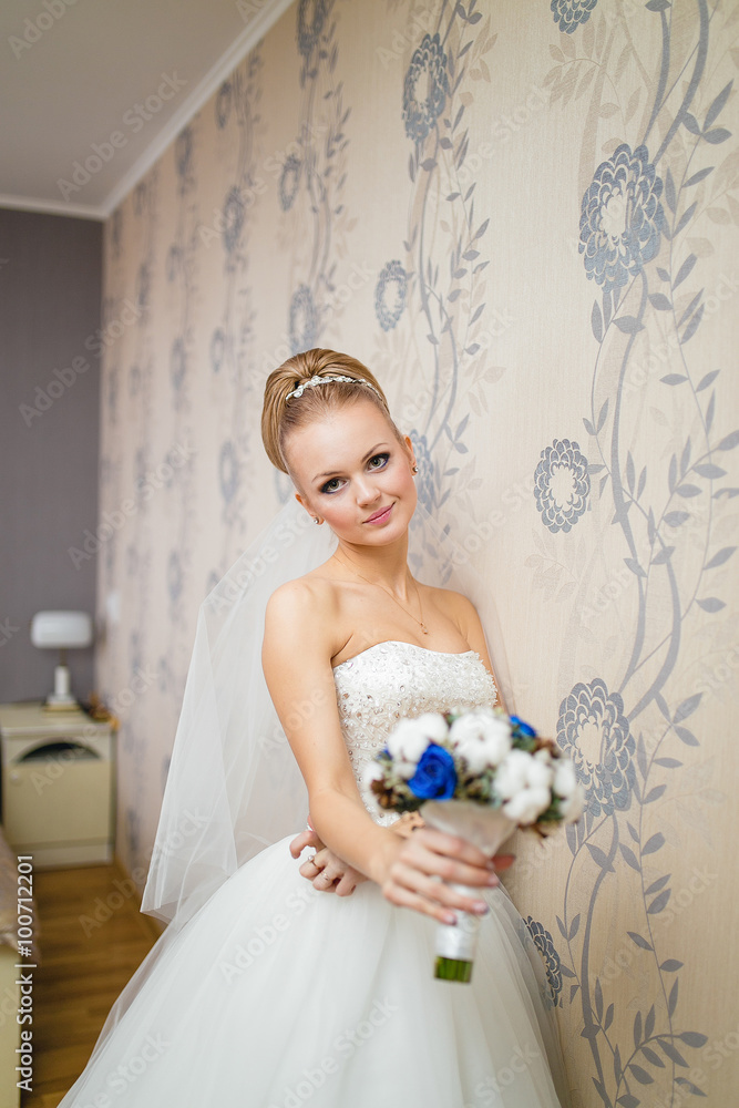 Gorgeous bride blonde in wedding dress in luxury interior posing Gorgeous bride blonde in wedding dress in luxury interior posing