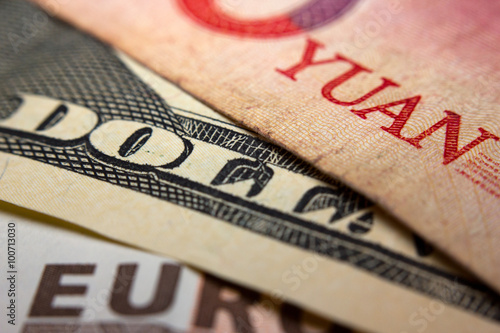 Close-up of an Chinese yuan, an American dollar and a Euro banknote