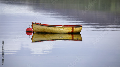 Boat moored to buoy in lake
