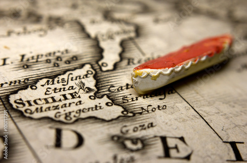 A boat and an antique map of Europe representing the immigration from the East