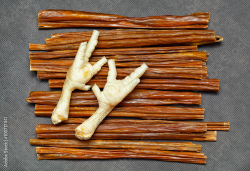 Obraz na plátně treats for pets - sticks of meat and chicken legs