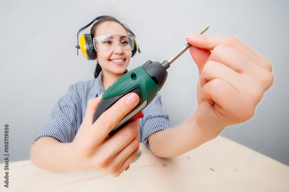 Young woman with a drill Young woman with a drill