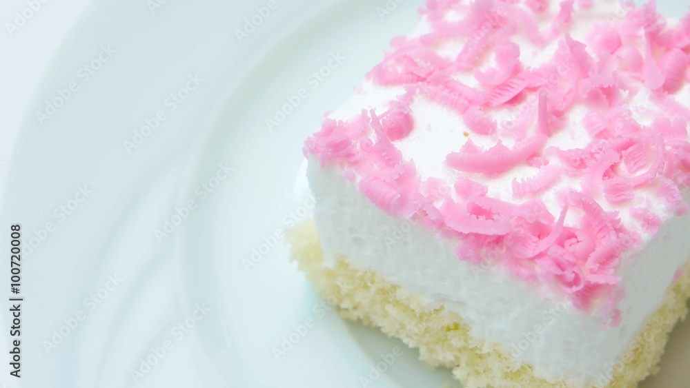 Edge of creamy cake with pink chips decoration. Rotates on white plate.
Edge of creamy cake with pink chips decoration. Rotates on white plate.
