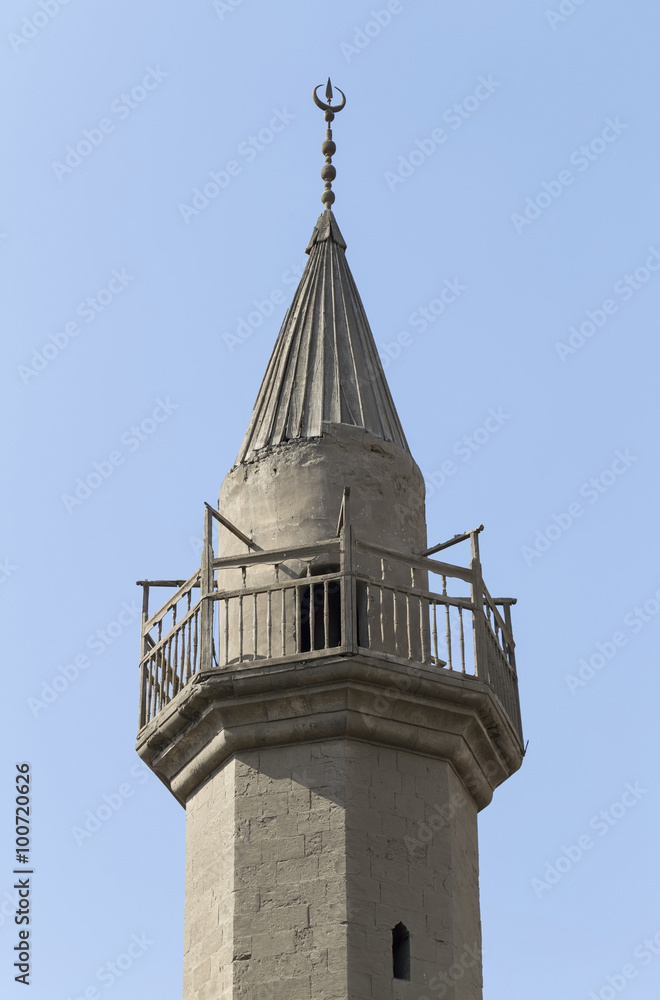 Old minaret of mosque against a bright blue sky,Islamic Cairo, E
