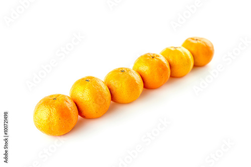 Diagonal line of oranges with copyspace against white