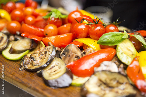 grilled vegetables on a wooden board