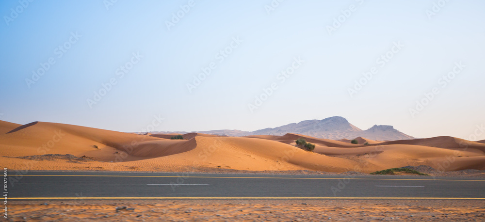 desert, sand dunes and the road in the evening