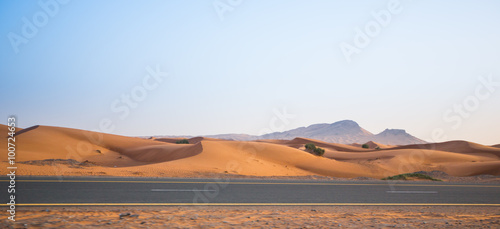desert  sand dunes and the road in the evening