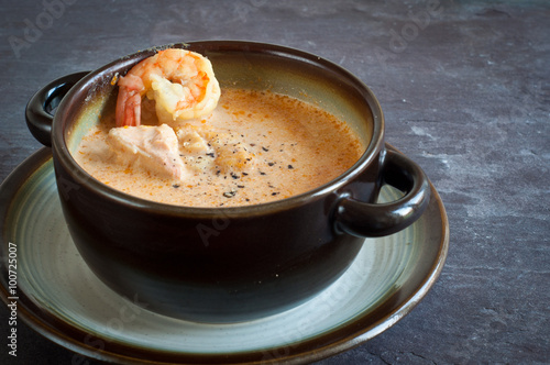 Icelandic fish soup with salmon and prawns. Served on a stone slate table.