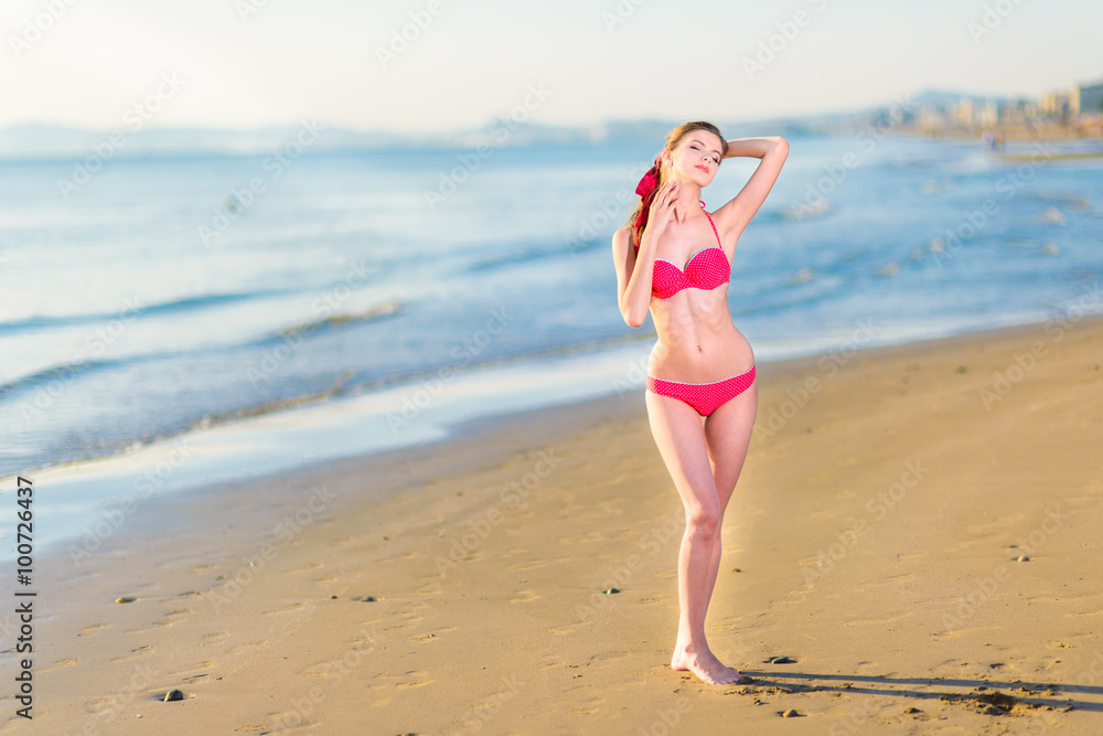 Beautiful young woman bikini pinup at beach