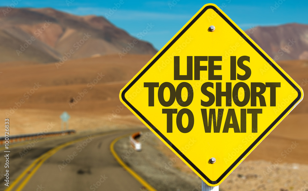 Life Is Too Short To Wait sign on desert road