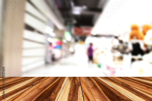 perspective wood and blurry supermarket/mall blur for background