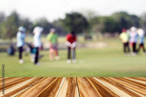 perspective wood and blurred golfers hit sweeping and keep golf