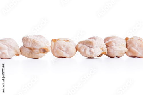 Align raw dry chickpeas on white background