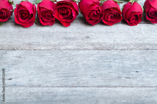 Red roses on woonden background. Valentine's day background. photo