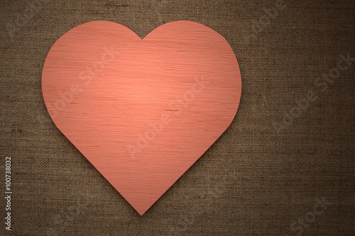 red wooden heart on burlap fabric