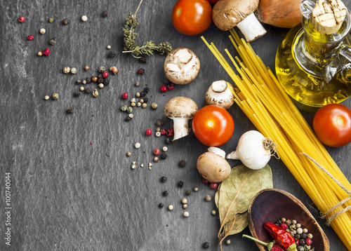 Italian meal ingredients with pasta,spices,tomatoes,olive oil an