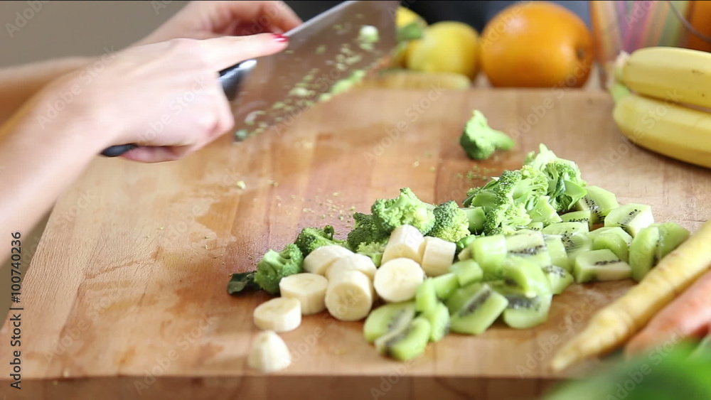 Close-up of cutting broccoli with knife Close-up of cutting broccoli with knife