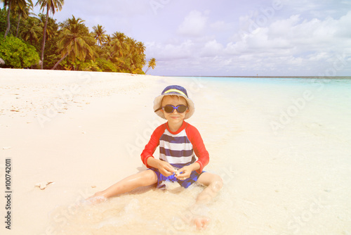 cute little boy relax on tropical beach