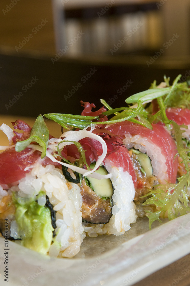 Ahi tuna sushi roll, avocado, and micro green garnish. Ahi tuna sushi roll, avocado, and micro green garnish.