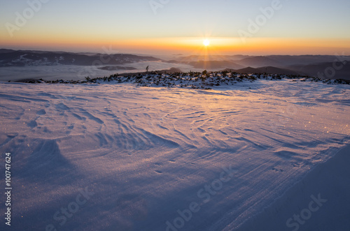 Winter sunrise over frozen landscape