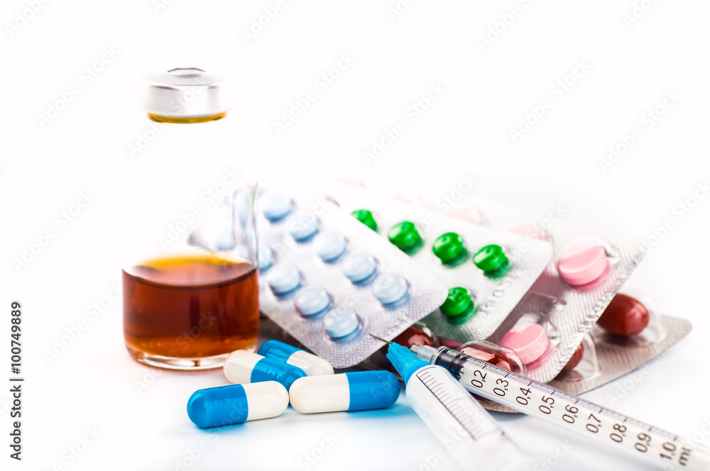 Medications tablets and capsules in a beaker Medications tablets and capsules in a beaker