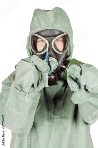 Man with protective mask and protective clothes holding a syring