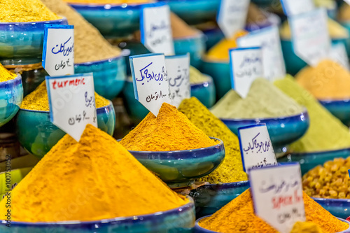 Exposed spices with prices in the store on the Vakil Bazaar in the Shiraz city centre, Iran.