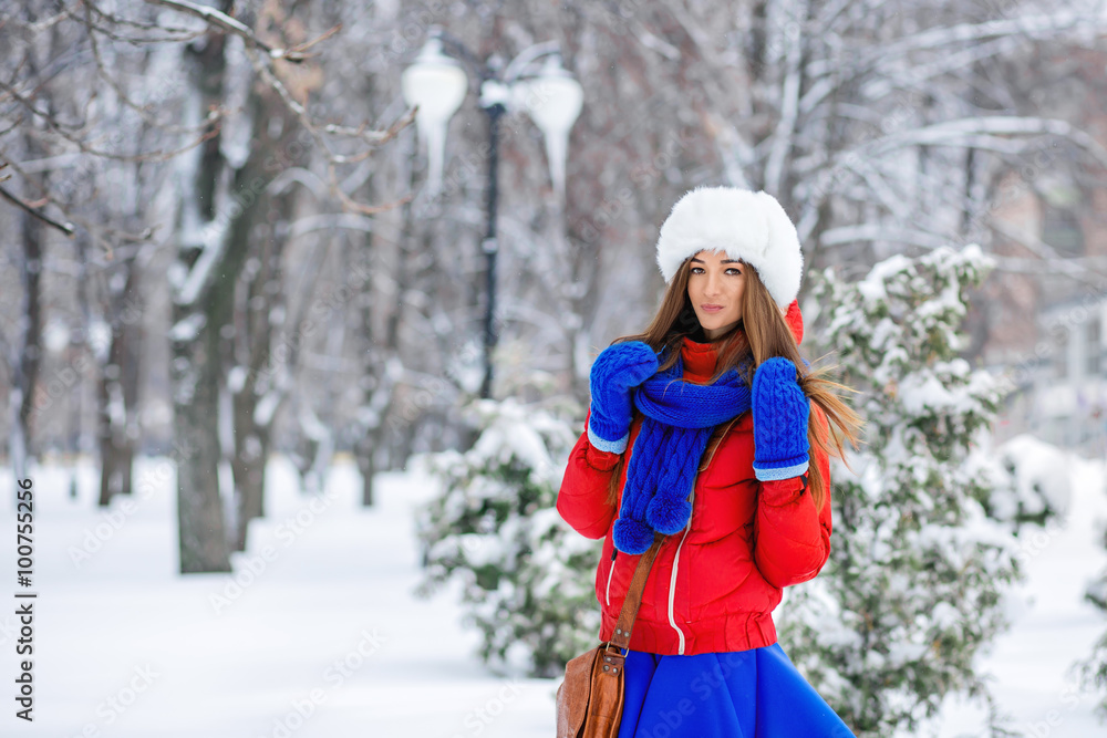 Fototapeta premium Beautiful winter portrait of young woman in the winter snowy sce