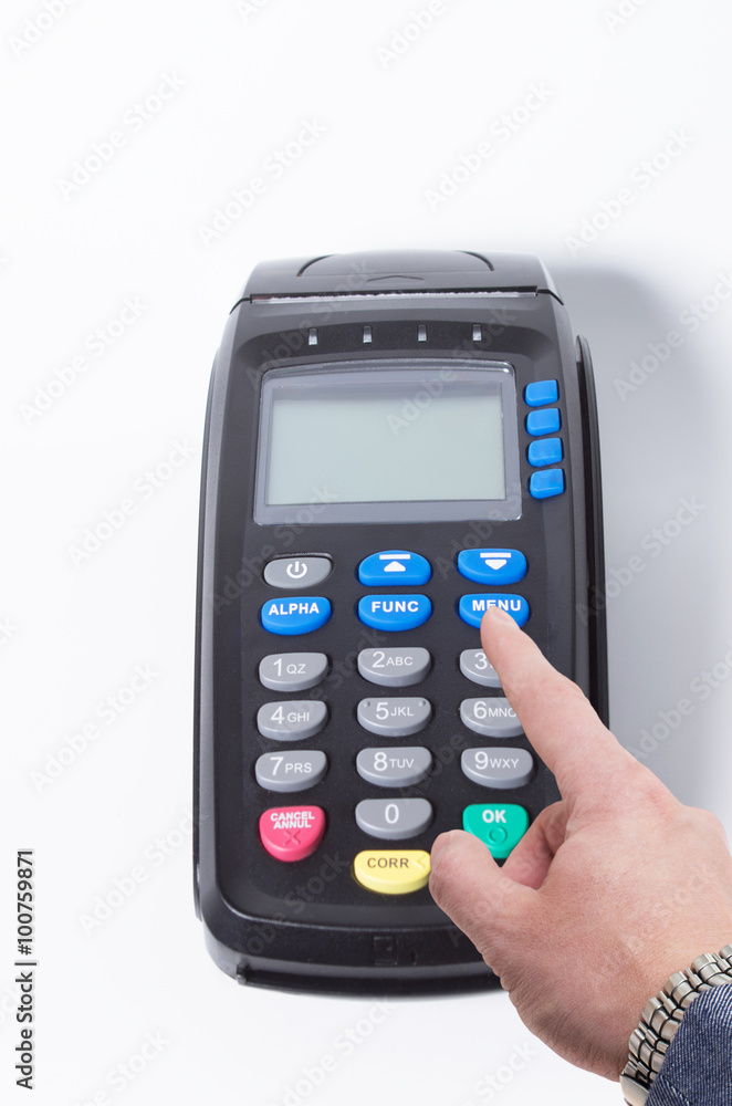 Male hand pressing menu button on a credit card machine Male hand pressing menu button on a credit card machine