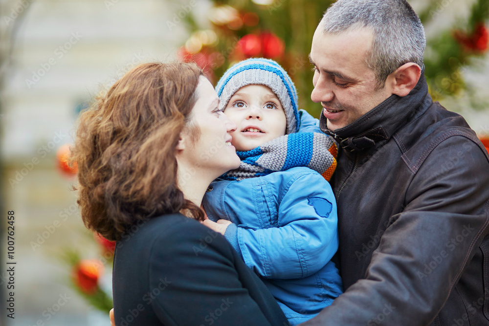 Fototapeta premium Happy family of three walking together in Paris