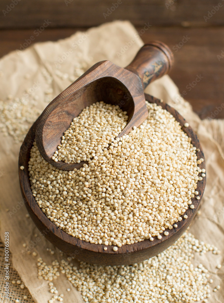 White Quinoa with a wooden spoon and bowl White Quinoa with a wooden spoon and bowl