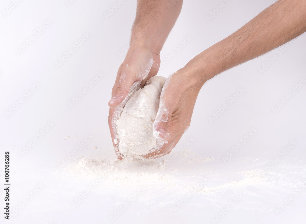 Fototapeta premium Kneading dough; close-up of male hands in flour kneading dough