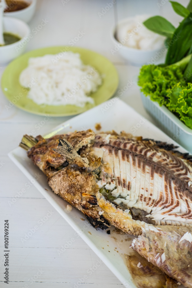 Closeup of salt grilled fish with spicy Thai dressing salad Closeup of salt grilled fish with spicy Thai dressing salad