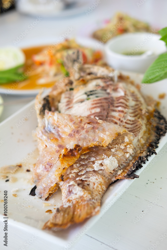 Closeup of salt grilled fish with spicy Thai dressing salad Closeup of salt grilled fish with spicy Thai dressing salad