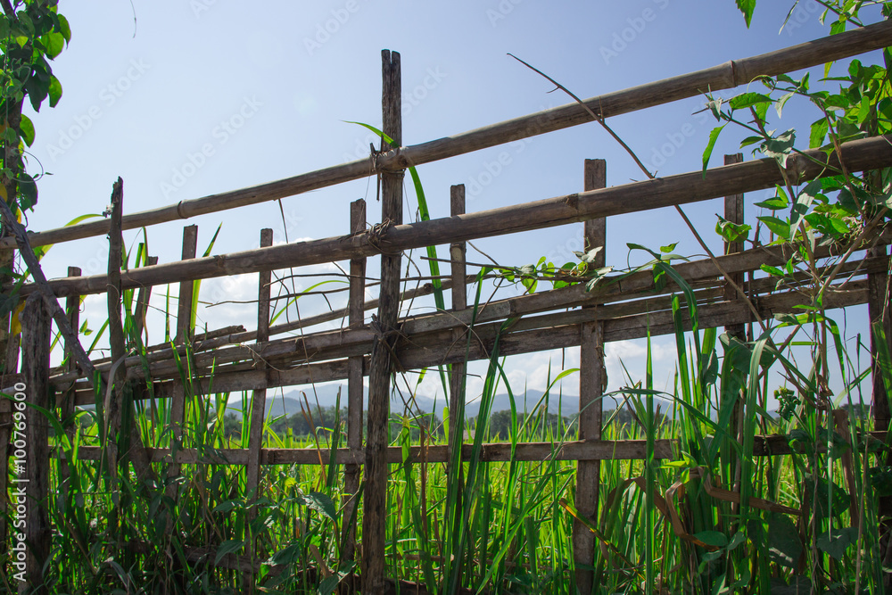 Wooden field fence and hills background