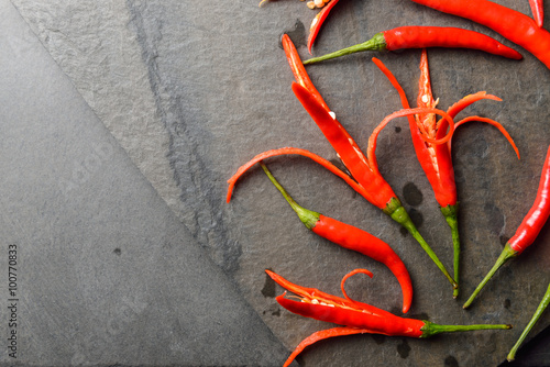Red chillies on rock and black background