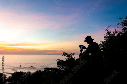Photographer sitting on a rock and enjoying the beautiful view