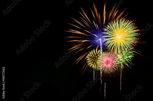 Colorful fireworks celebration on dark background.