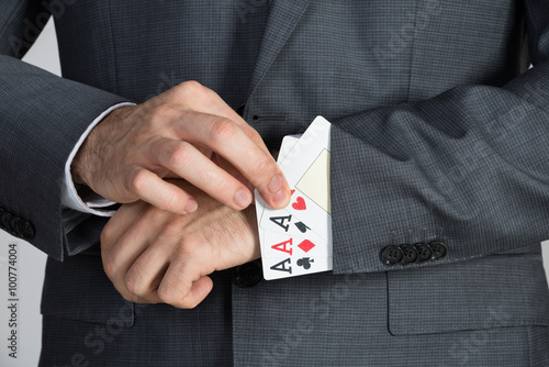 Businessman Removing Ace Cards From Sleeve
