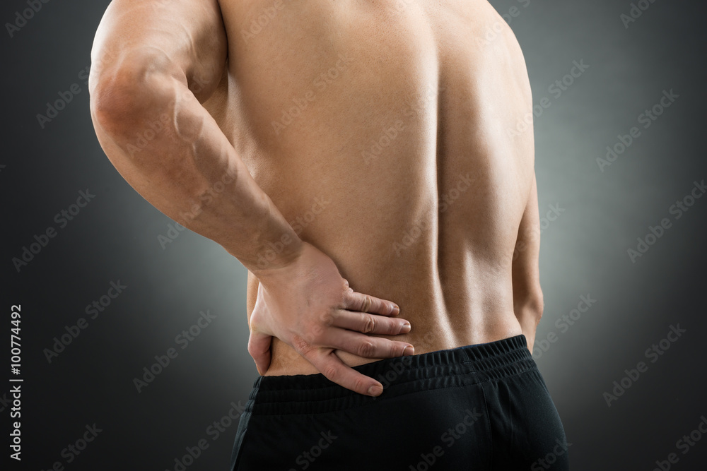 Midsection Of Muscular Man Suffering From Backache Midsection Of Muscular Man Suffering From Backache