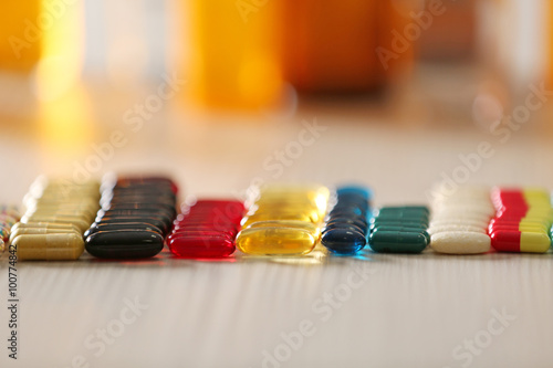 Colourful drugs in a row on the table, close up