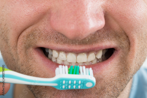 Closeup Of Man Brushing Teeth