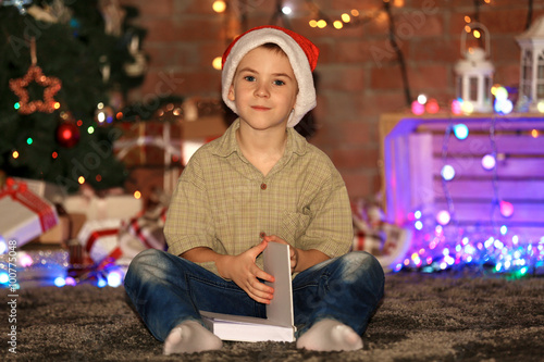 Little boy with book sittin...