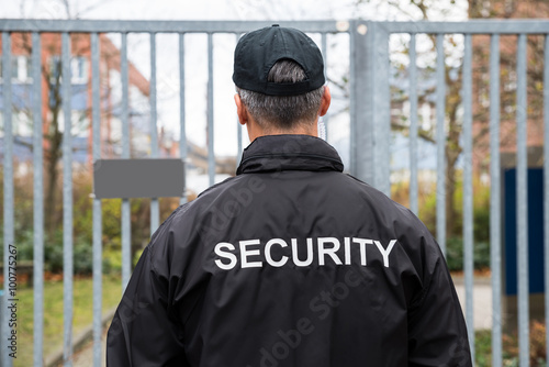 Security Guard Standing In Front Of Gate