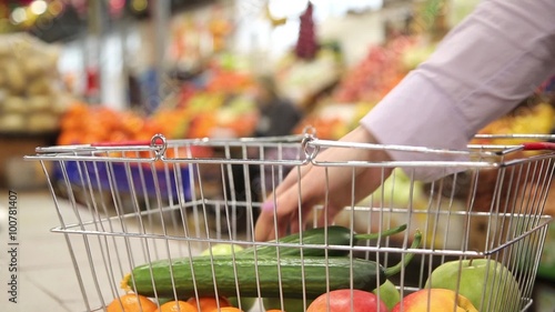 Shopping cart with vegetables on the background of the market
