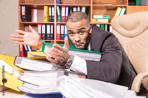 unhappy man with a lot of paperwork
